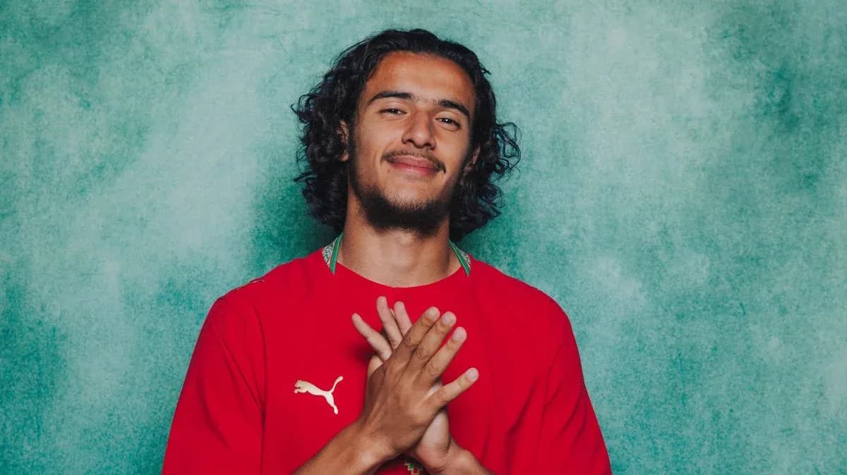 Player posing in red jersey with clasped hands Player posing in red jersey with clasped hands