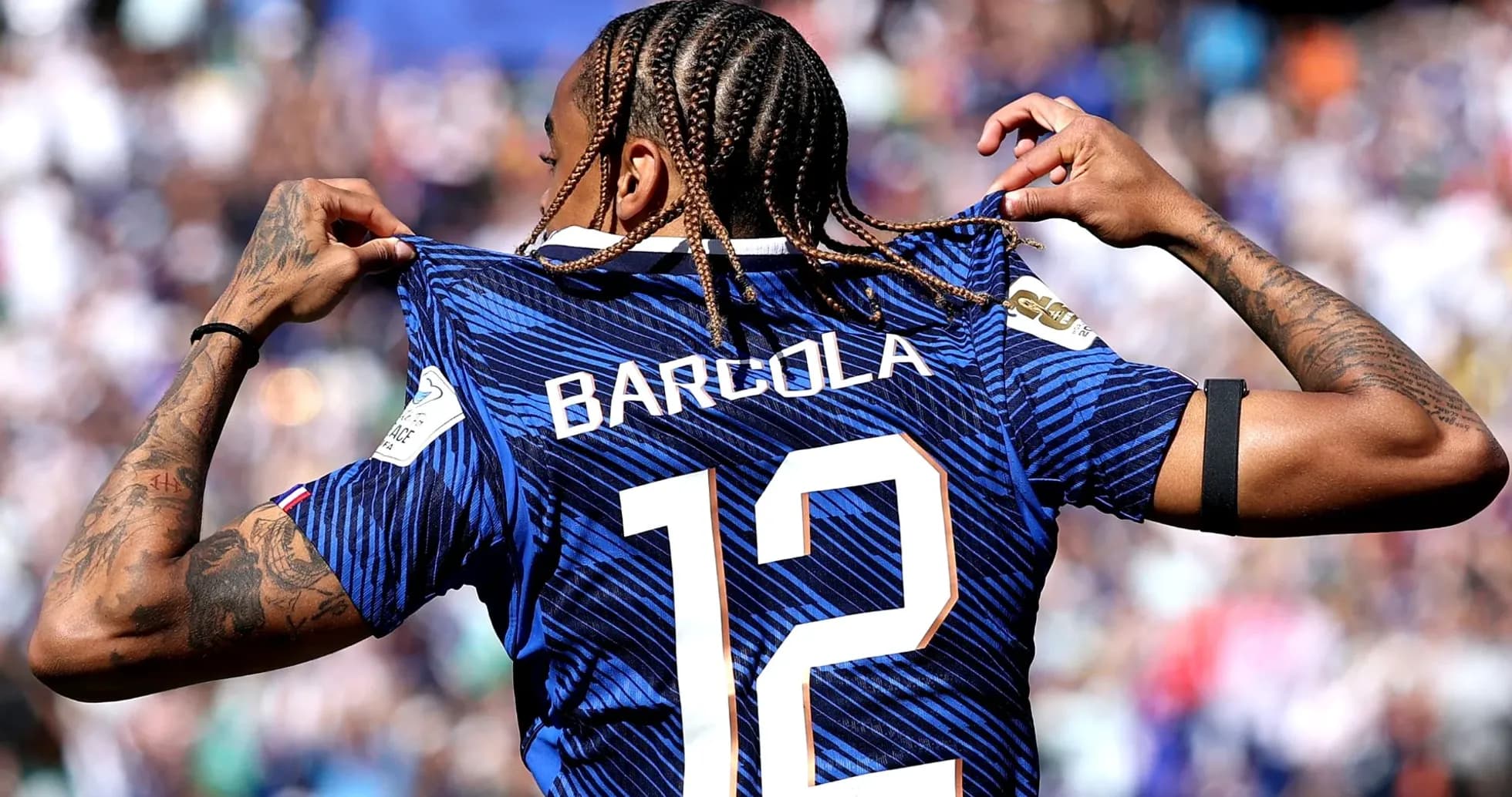 Player showcasing jersey with 'Barcola' and number 12 Player showcasing jersey with 'Barcola' and number 12