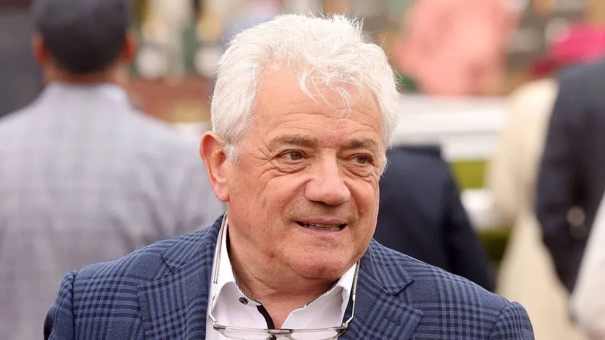 Man in a blazer at an outdoor event Man in a blazer at an outdoor event
