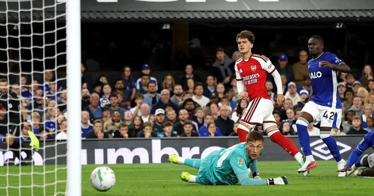 Arsenal player celebrates after scoring against goalkeeper Arsenal player celebrates after scoring against goalkeeper
