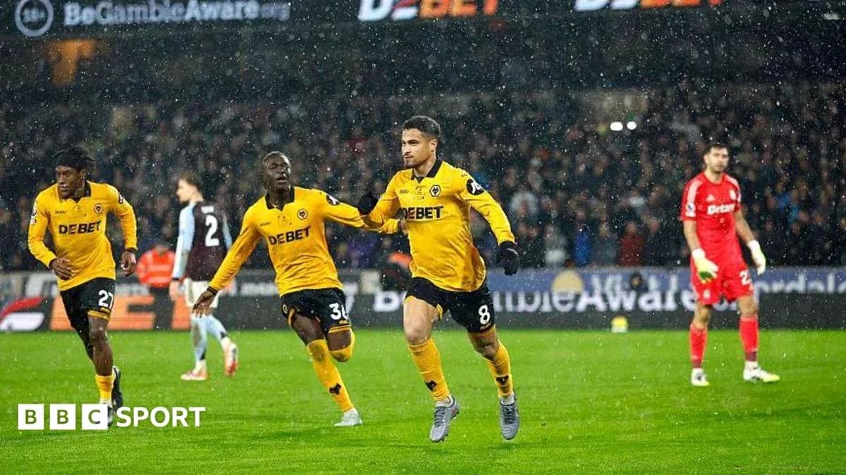 Player celebrating a goal in rainy football match Player celebrating a goal in rainy football match