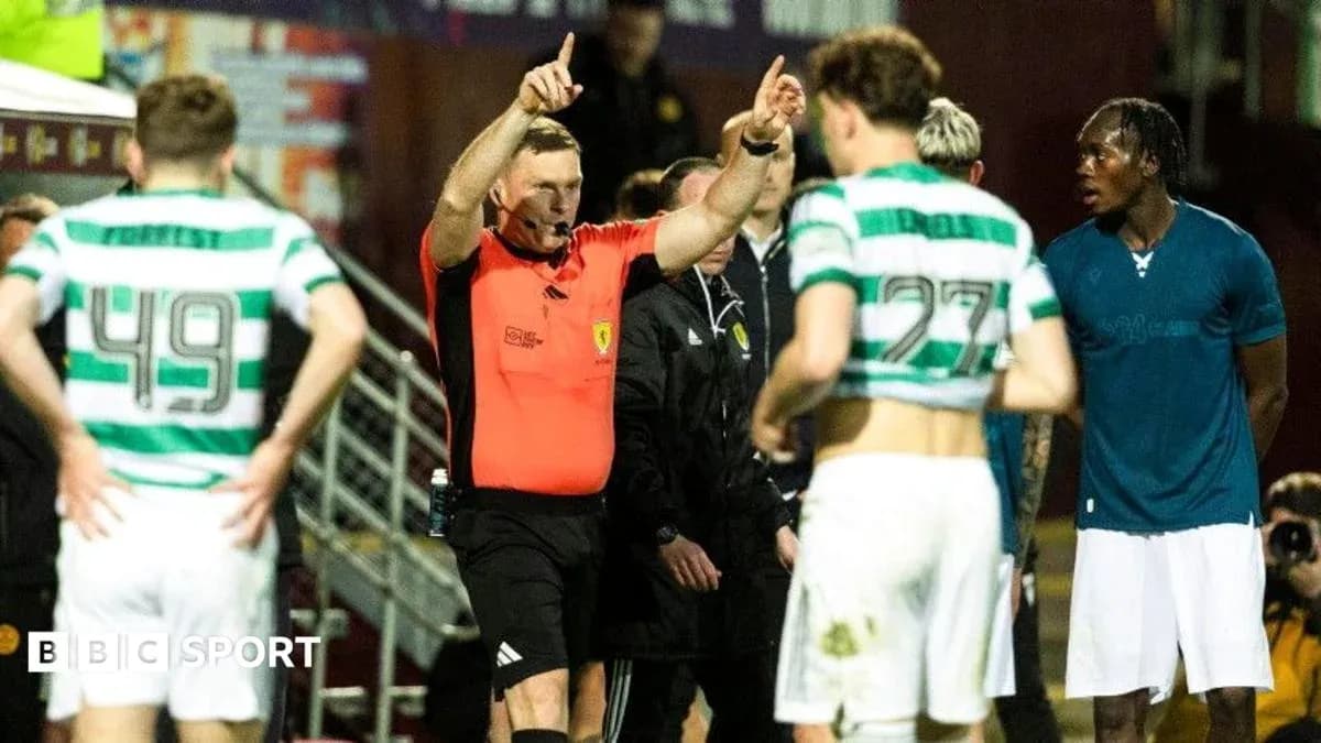 Referee signaling during match with players nearby Referee signaling during match with players nearby