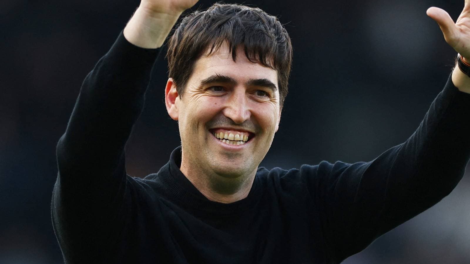 Coach celebrating with raised arms after match Coach celebrating with raised arms after match