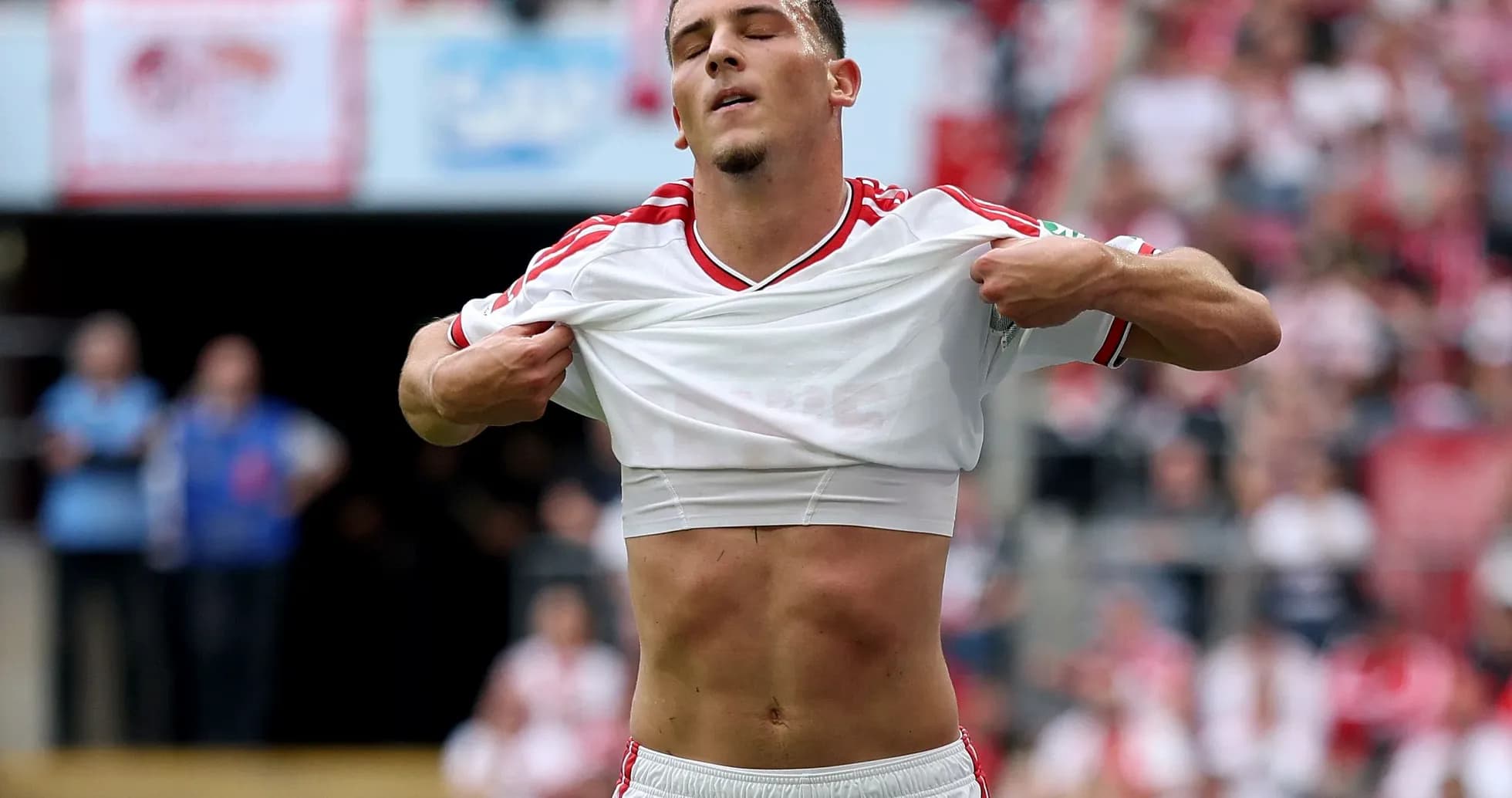 Player lifting shirt during football match celebration Player lifting shirt during football match celebration