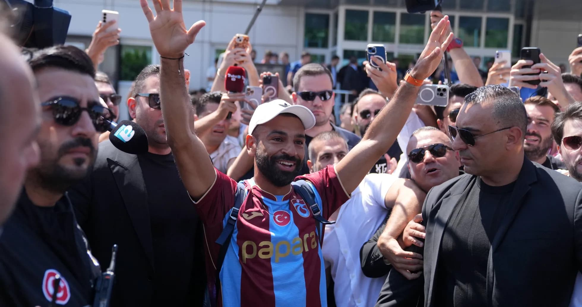 Player greeting fans while surrounded by crowd Player greeting fans while surrounded by crowd