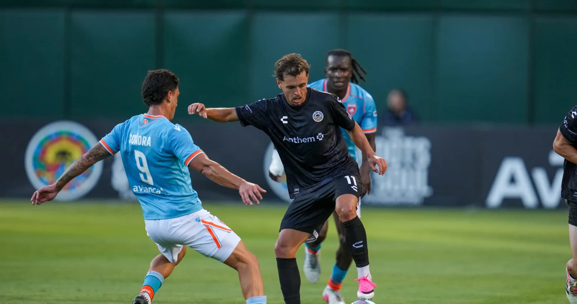 Player dribbling past opponent during USL match Player dribbling past opponent during USL match