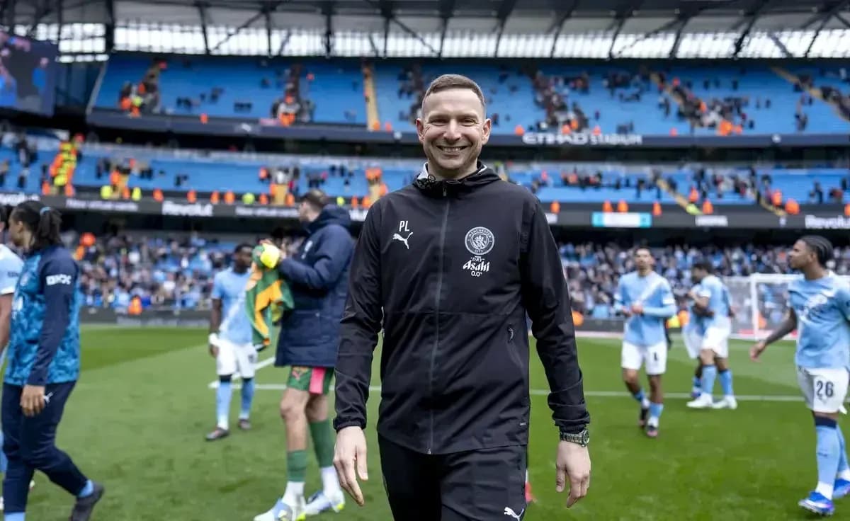 Coach smiling while walking off the pitch Coach smiling while walking off the pitch