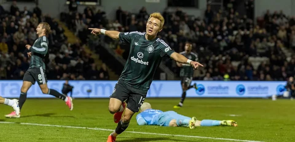 Player celebrating goal with teammates in match Player celebrating goal with teammates in match