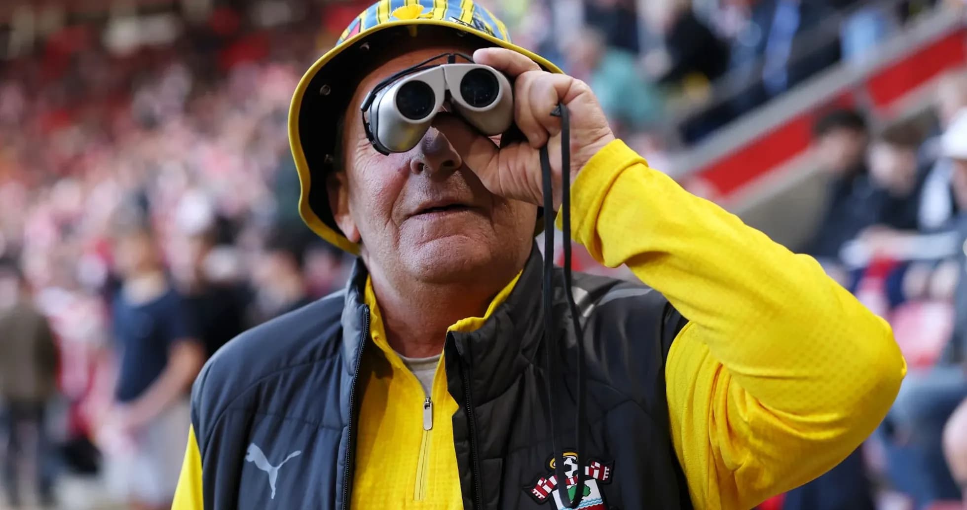 Fan wearing binoculars and Southampton gear at match Fan wearing binoculars and Southampton gear at match