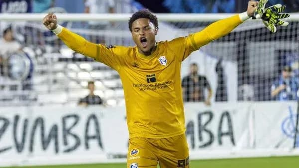 Goalkeeper celebrating a save during a match Goalkeeper celebrating a save during a match