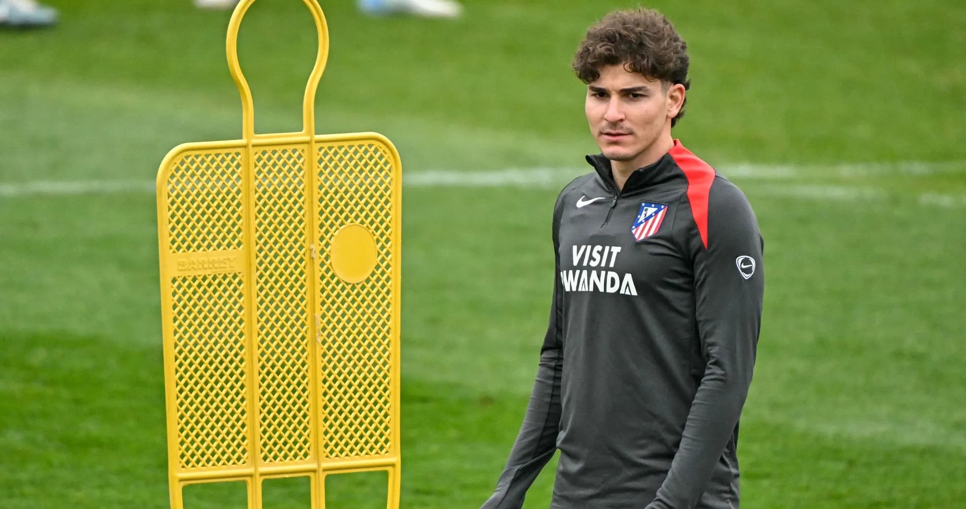 Player standing next to a training dummy on pitch Player standing next to a training dummy on pitch
