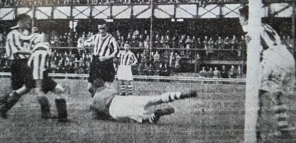 Players contesting near goal during historic match Players contesting near goal during historic match