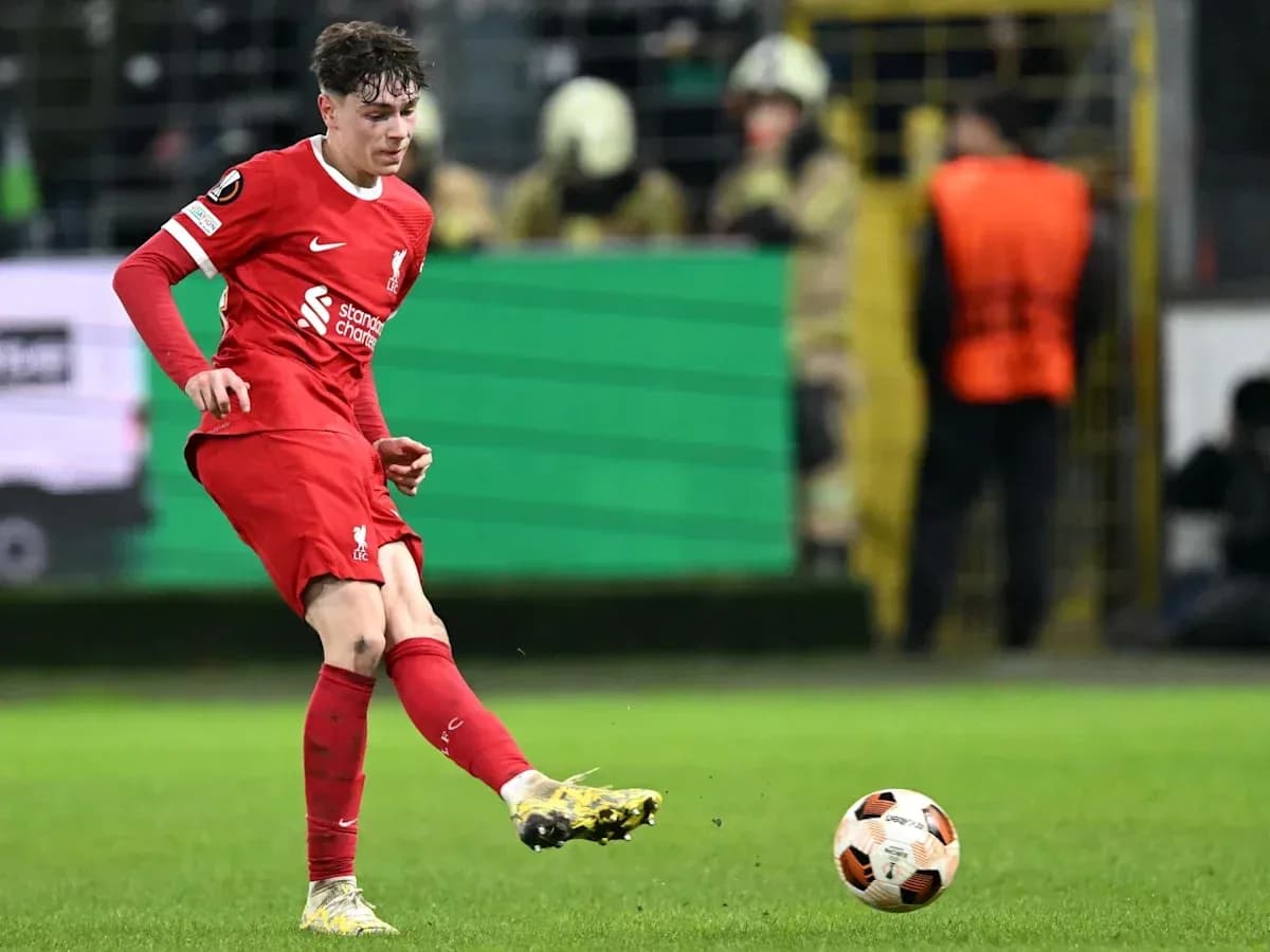 Player in red kit kicking ball during match Player in red kit kicking ball during match