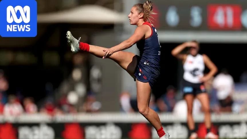 Player kicking the ball during Australian rules football match Player kicking the ball during Australian rules football match