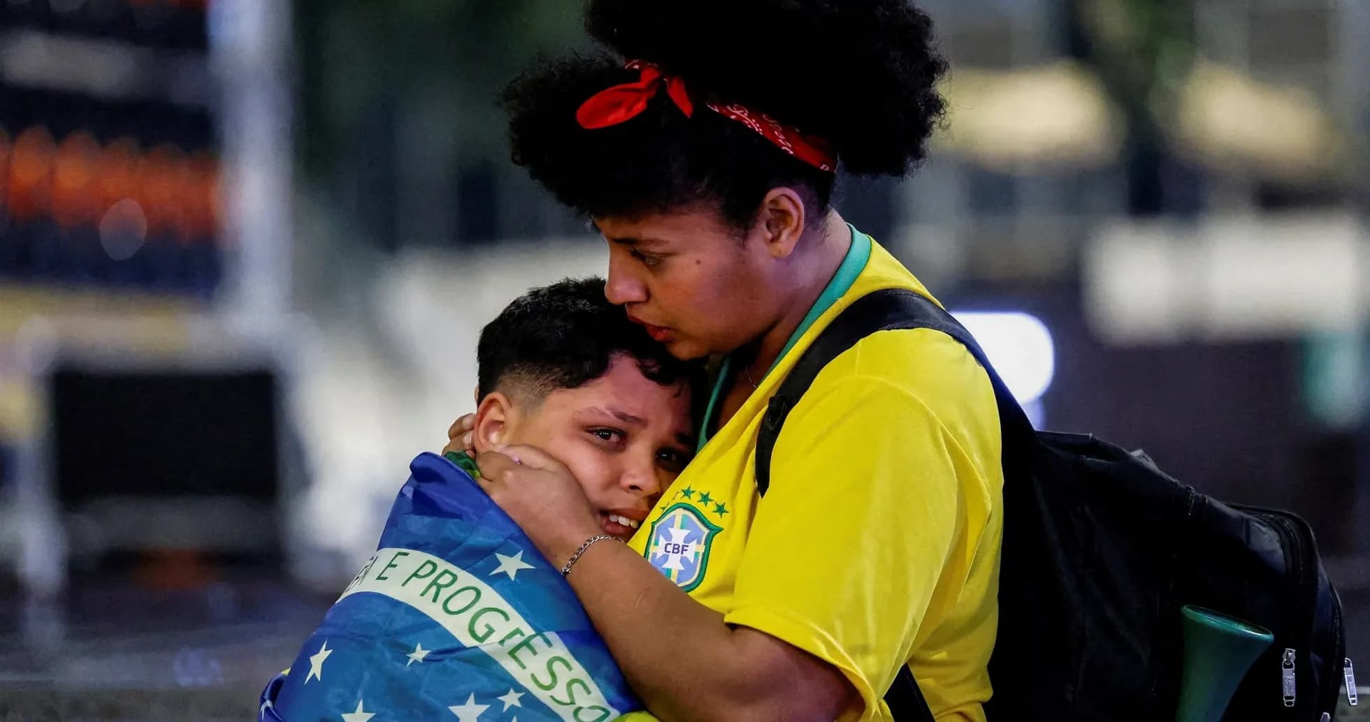 Two fans embracing, wrapped in Brazilian flag Two fans embracing, wrapped in Brazilian flag