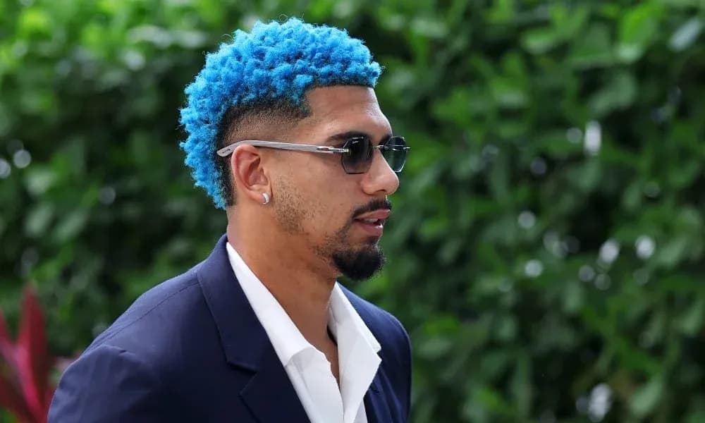 Person with blue hair wearing sunglasses outdoors Person with blue hair wearing sunglasses outdoors