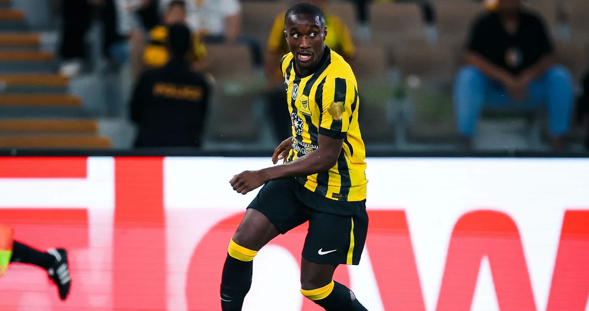 Player in yellow and black jersey during match Player in yellow and black jersey during match