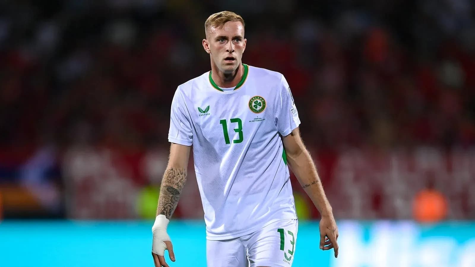 Player wearing white jersey during football match Player wearing white jersey during football match
