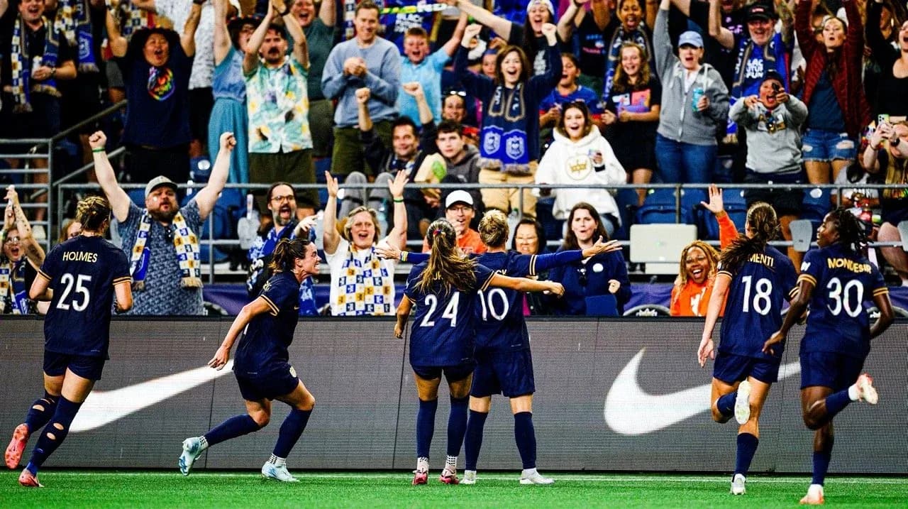 Seattle Reign FC players celebrating a goal Seattle Reign FC players celebrating a goal
