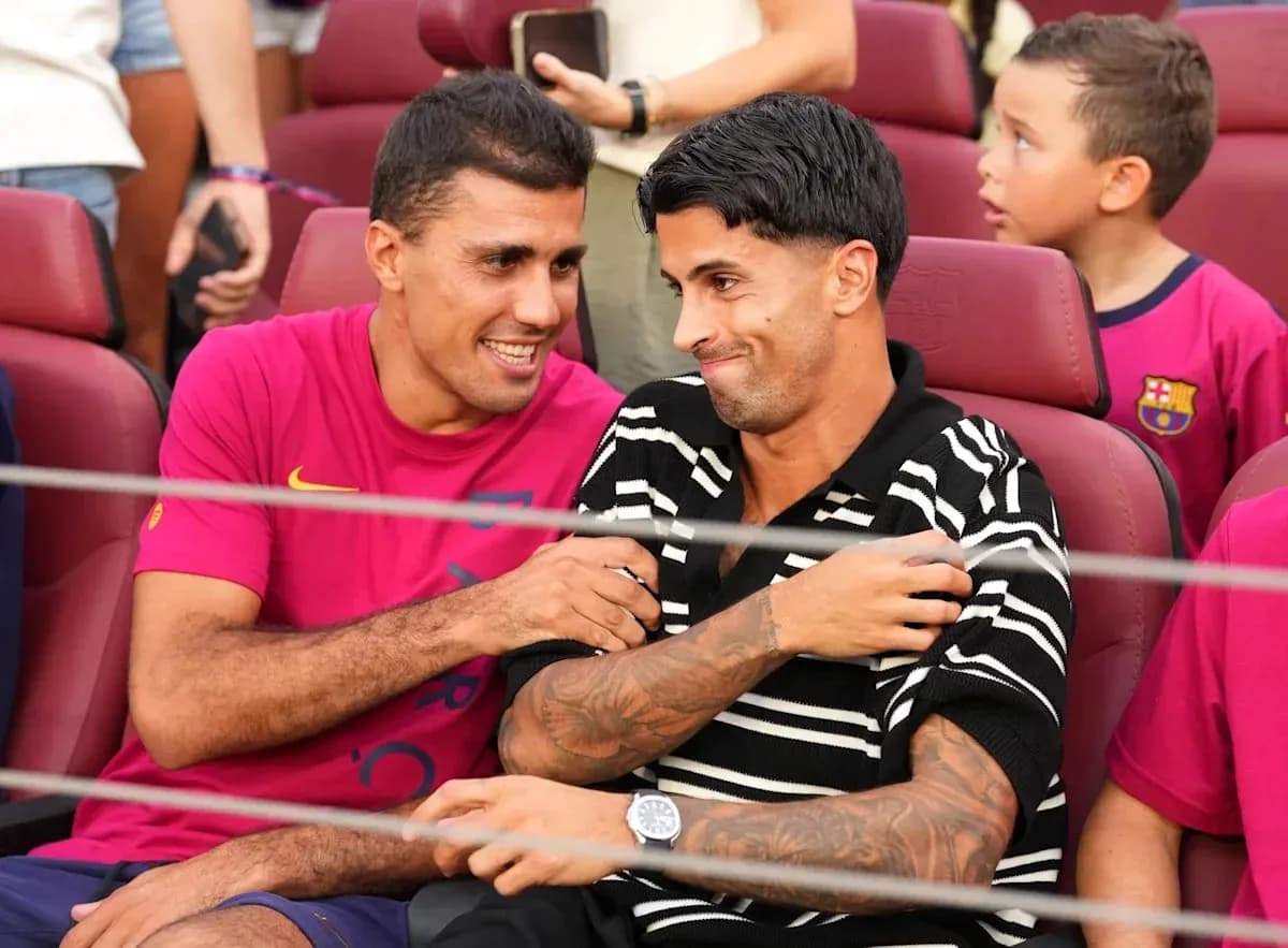 Two players laughing together in stadium seats Two players laughing together in stadium seats