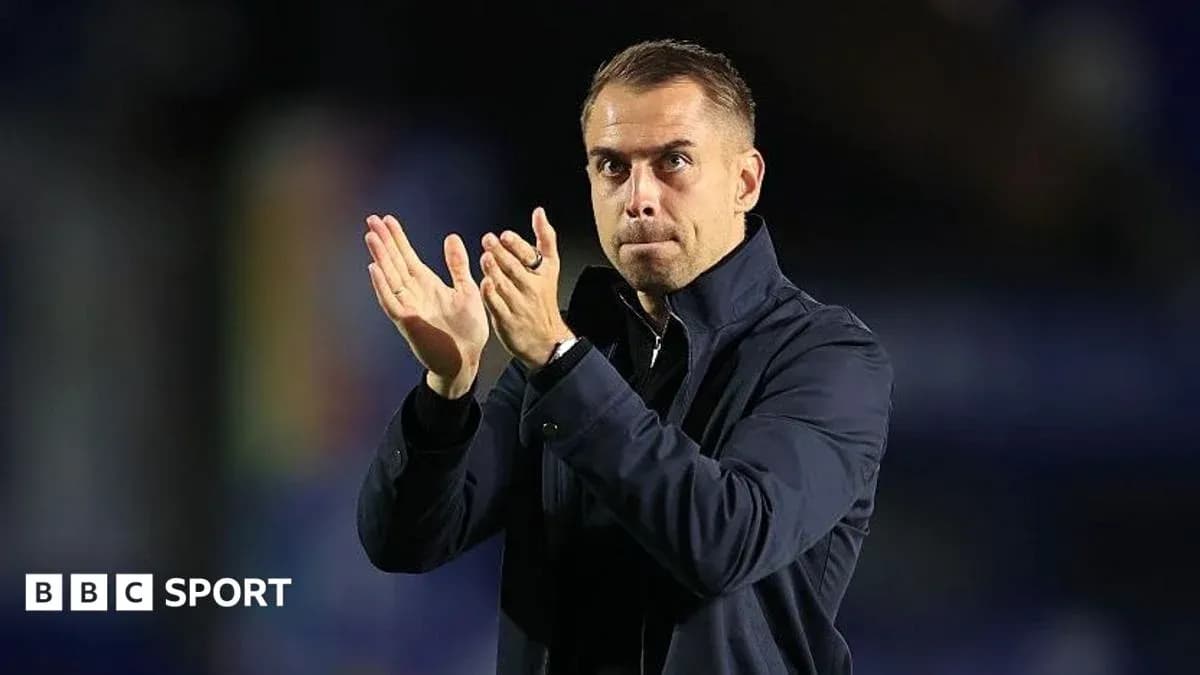 Coach applauding during a match or event Coach applauding during a match or event
