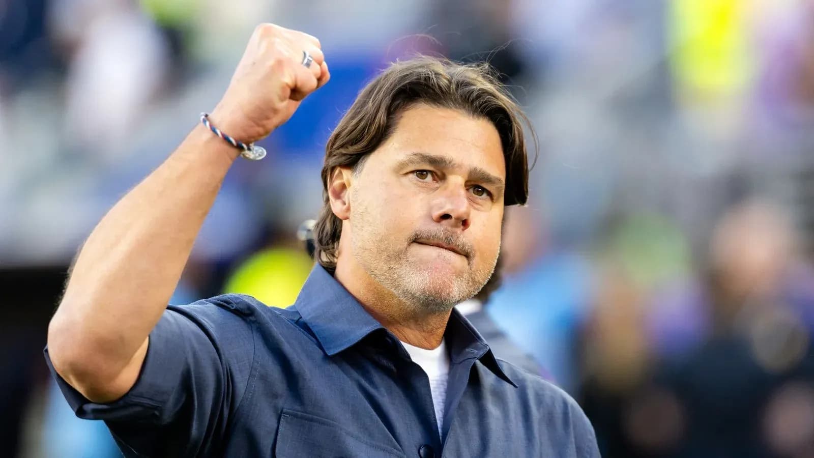Coach celebrating with raised fist on field Coach celebrating with raised fist on field