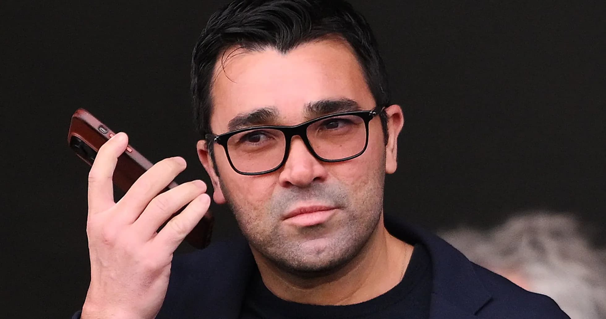 Man holding a phone while looking thoughtfully Man holding a phone while looking thoughtfully