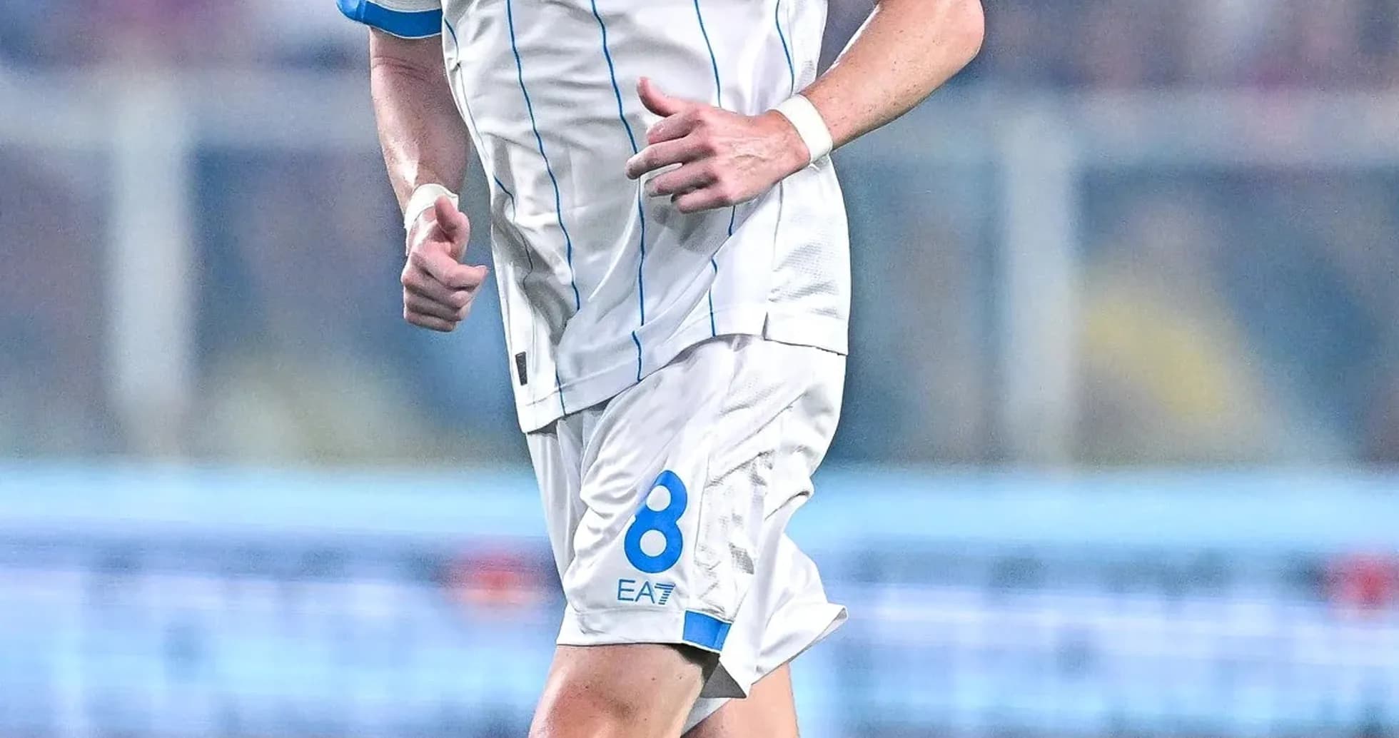 Player in Napoli kit running during match Player in Napoli kit running during match