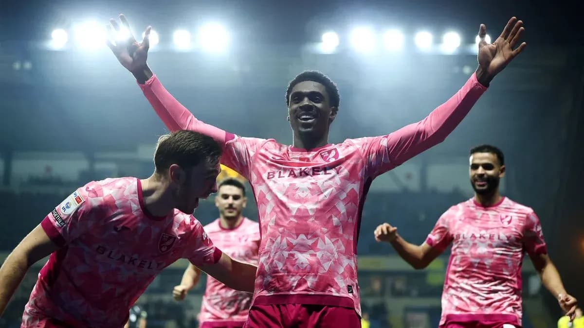 Players celebrating a goal with raised arms Players celebrating a goal with raised arms