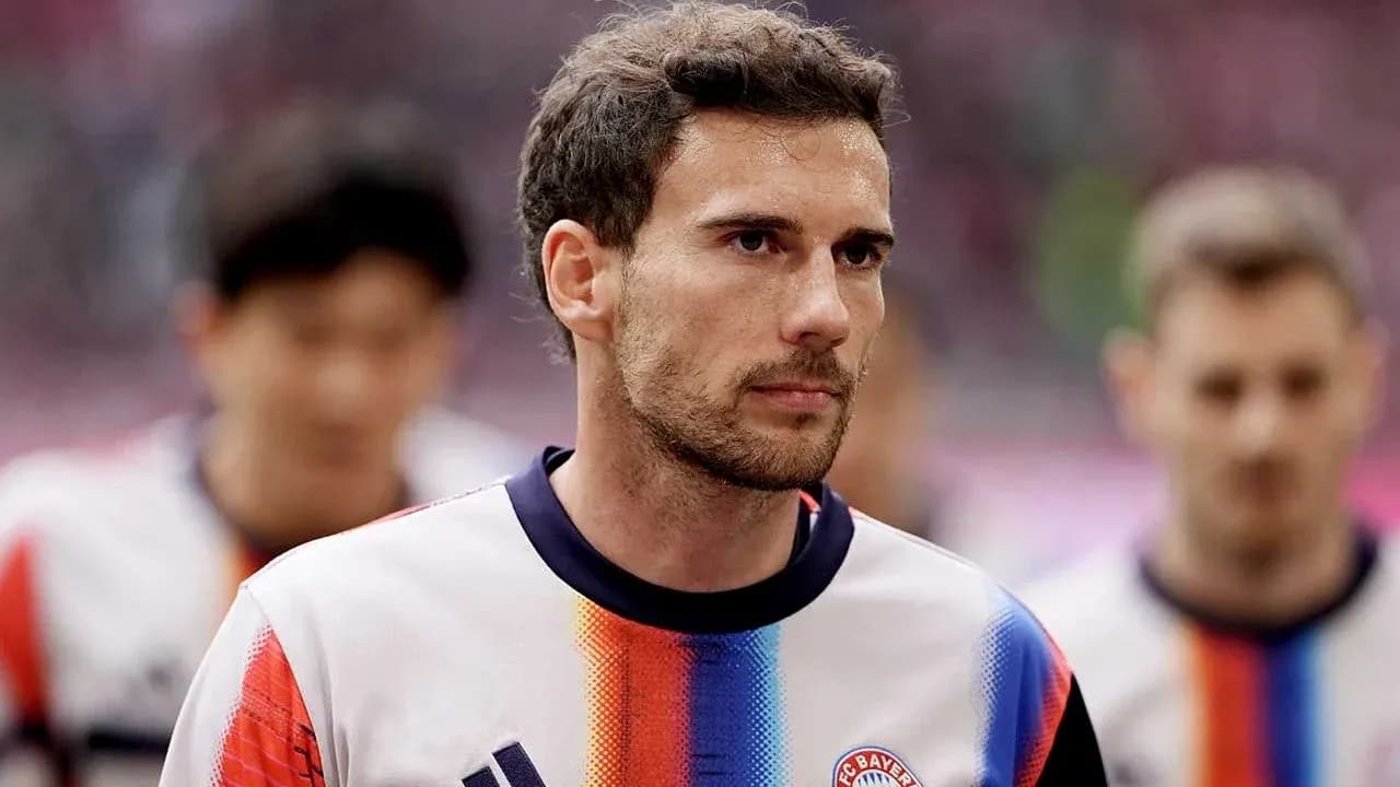 Player walking onto the pitch in team uniform Player walking onto the pitch in team uniform