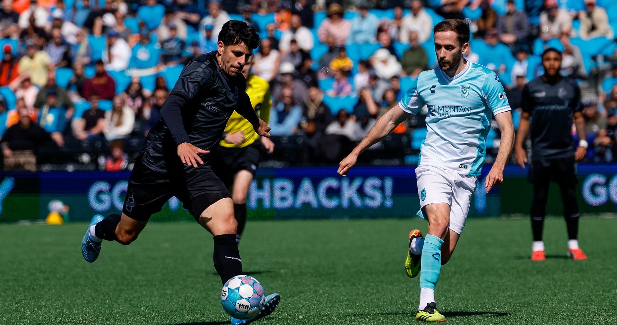 Monterey Bay player dribbling past Loudoun United opponent Monterey Bay player dribbling past Loudoun United opponent