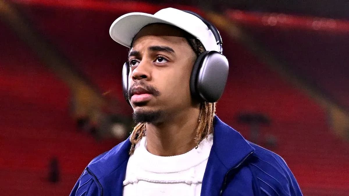 Player wearing headphones walking in stadium Player wearing headphones walking in stadium